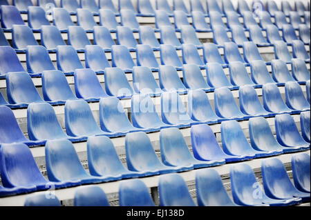 Empty blue seats on sport arena tribune after the rain Stock Photo