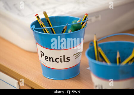 Pots of coloured pencils in a UK primary school classroom Stock Photo