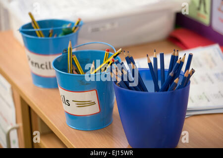 Pots of coloured pencils in a UK primary school classroom Stock Photo