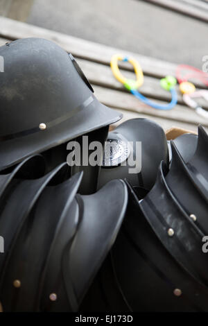 A pile of toy policemans helmets in a school playground Stock Photo