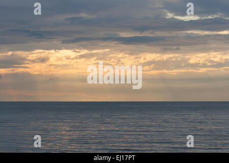 light rays falling through clouds on the Adriatic sea surface Stock Photo