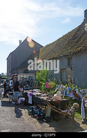 The Grand Rue of Gigny-sûr-Saône, is lined with tables for the August marché aux puces, Burgundy, France. Stock Photo