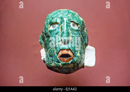 small vivid jade mask found as a funerary offering in tomb of Red Queen displayed in the Archaeological museum Palenque Chiapas Stock Photo