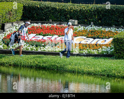 Orlando, FL, USA. 19th Mar, 2015. Alexander Levy of France and his caddy walk in front of the Master Card sign after hitting his ball left of the green on #8 during first round golf action of the Arnold Palmer Invitational presented by Mastercard held at Arnold Palmer's Bay Hill Club & Lodge in Orlando, FL Credit:  csm/Alamy Live News Stock Photo