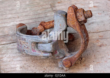 Dirty rusty scaffold clip laid on a scoffold board Stock Photo