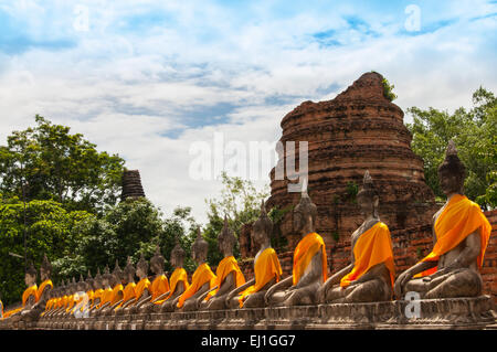 AYUTTHAYA,THAILAND-JUNE 27, 2013: Aligned statues of Buddha in Wat yai chai mong kol Stock Photo