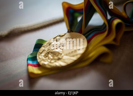 Breitenbrunn, Germany. 11th Mar, 2015. Former German athlete Baerbel Woeckel, shows one of her gold medals in her house in Breitenbrunn, Germany, 11 March 2015. Woeckel won four Olympic gold medals in 1976 and 1980 in the 200 meter and the 4x 100 meter relay. Today she works for the Deutscher Leichtathletik-Verband (German Athletics Association). Photo: Frank Rumpenhorst/lhe/dpa/Alamy Live News Stock Photo