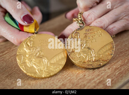 Breitenbrunn, Germany. 11th Mar, 2015. Former German athlete Baerbel Woeckel, shows two of her gold medals in her house in Breitenbrunn, Germany, 11 March 2015. Woeckel won four Olympic gold medals in 1976 and 1980 in the 200 meter and the 4x 100 meter relay. Today she works for the Deutscher Leichtathletik-Verband (German Athletics Association). Photo: Frank Rumpenhorst/lhe/dpa/Alamy Live News Stock Photo