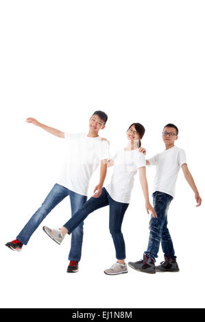 Teenagers standing with one leg and smiling at the camera Stock Photo