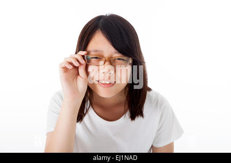 Teenage girl holding glasses and smiling at the camera Stock Photo