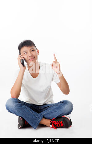 Teenage boy looking away with smile and on the phone Stock Photo