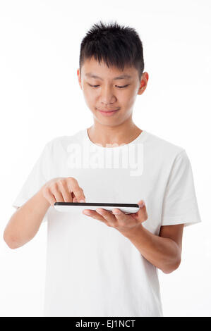 Teenage boy holding touch pad and touching with smile Stock Photo