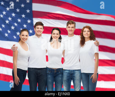 group of smiling teenagers in white blank t-shirts Stock Photo