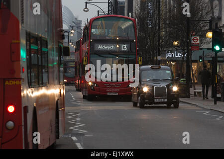 London, UK. 20 March 2015. A thick layer of clouds stopped Londoners from experiencing the 2015 Solar Eclipse. Instead, it was a dull and gloomy morning with grey skies. In Oxford Street many car and street lights came on as commuters made their way into work at the height of the eclipse. Credit:  Nick Savage/Alamy Live News Stock Photo