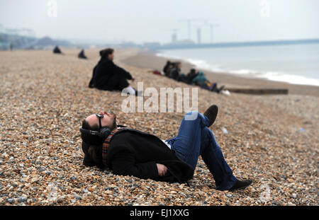 Brighton Sussex UK 20th March 2015 - People on Brighton beach this morning to view the Partial Solar Eclipse of the Sun which is taking place throughout Britain . Unfortunately the weather conditions were overcast and cloudy and a few glimpses were possible on the south coast Credit:  Simon Dack/Alamy Live News Stock Photo