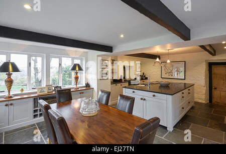 A White country style kitchen with dining area in a farmhouse in the UK. Stock Photo