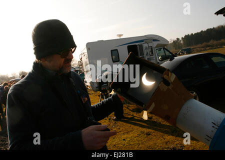 Madley, Herefordshire UK. 20th March, 2015. An amateur astrologer from the Herefordshire Astronomical Society watching the moon pass across the sun during the eclipse through his telescope under clear blue skies in rural Herefordshire. Stock Photo