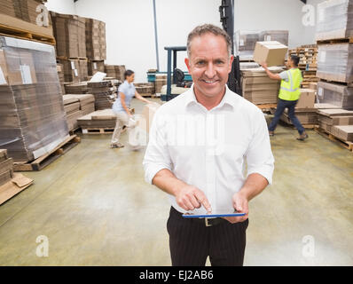 Manager using digital tablet during busy period Stock Photo