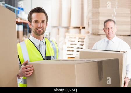 Delivery driver loading his van with boxes Stock Photo