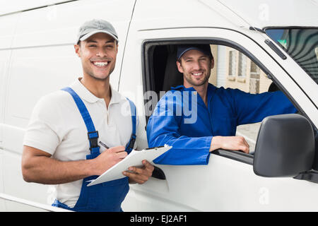Delivery man getting signature from customer Stock Photo