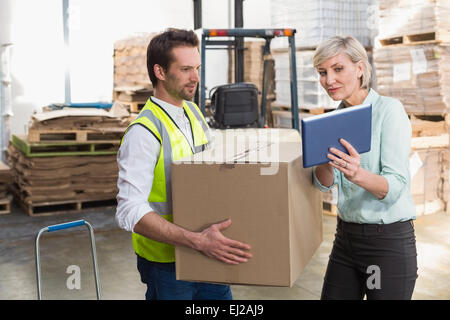 Warehouse worker and manager using tablet pc Stock Photo
