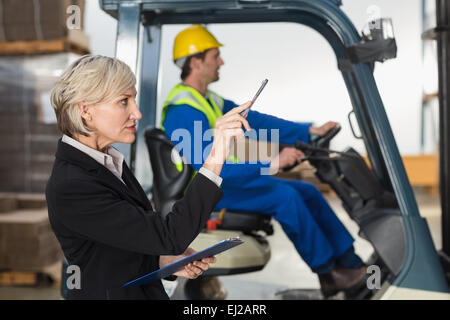 Warehouse manager checking her inventory Stock Photo