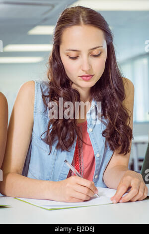 Student taking notes in class Stock Photo