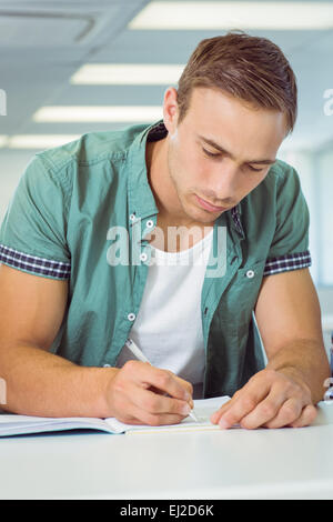 Student taking notes in class Stock Photo