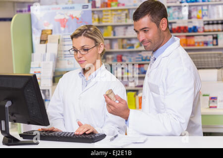 Team of pharmacists looking at the computer Stock Photo