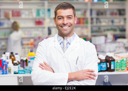 Smiling pharmacist in lab coat looking at camera Stock Photo