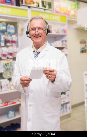 Smiling senior pharmacist with headphone Stock Photo