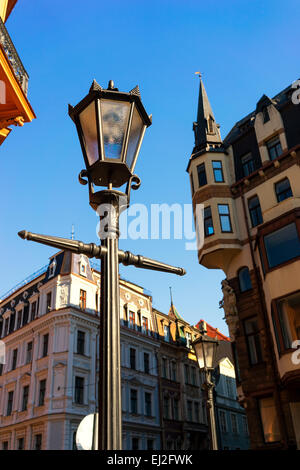 Stylish street light on the background of medieval facades with spiers of Riga in the spring blue sky. Vecriga. Latvia, Baltic Stock Photo