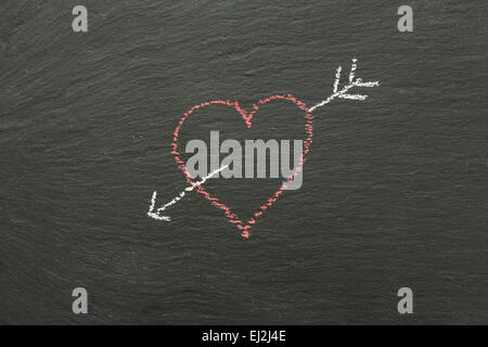 Chalk heart with arrow drawn on a chalk board.. Stock Photo