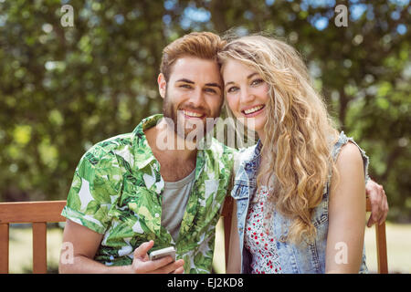 Young couple relaxing on park bench Stock Photo