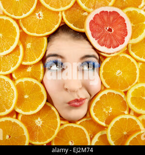 Beautiful woman expression face with orange slice frame Stock Photo