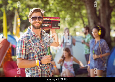 Handsome hipster holding retro cassette player Stock Photo