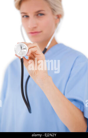Blonde doctor listening with stethoscope Stock Photo