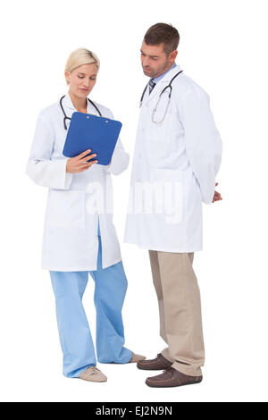 Doctors discussing something on clipboard Stock Photo