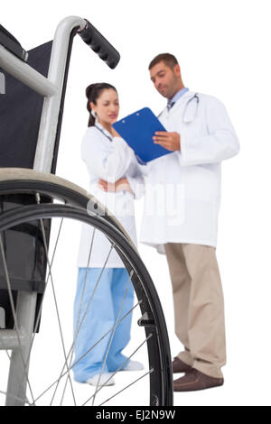 Doctors discussing something on clipboard Stock Photo