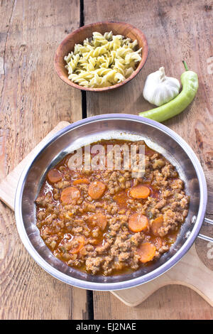 Minced meat sauce with vegetables cooked in pan with pasta Stock Photo