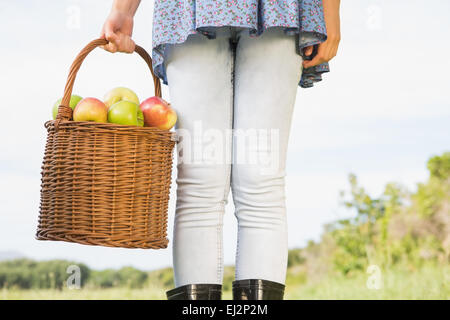Woman holding basket of apples Stock Photo