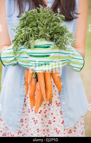Woman holding her organic carrots Stock Photo