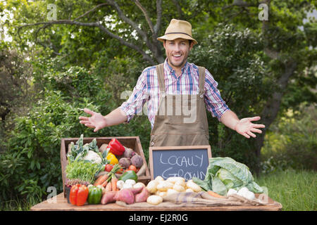 Happy farmer showing his produce Stock Photo - Alamy