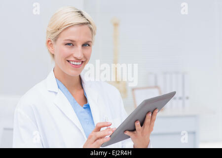 Confident female doctor using digital tablet Stock Photo