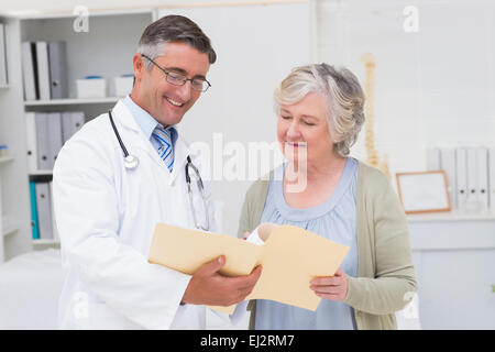 Doctor and patient discussing over reports Stock Photo
