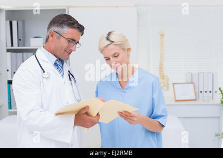 Doctor and nurse discussing over reports Stock Photo