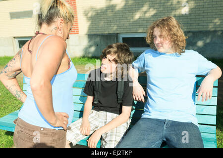 woman drug dealer at playground school. Stock Photo
