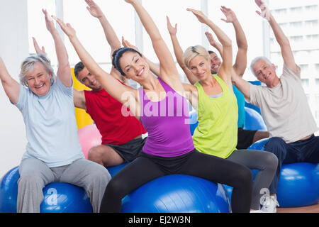 Happy people exercising in gym class Stock Photo