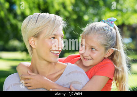 Happy blonde with her daughter in the park Stock Photo