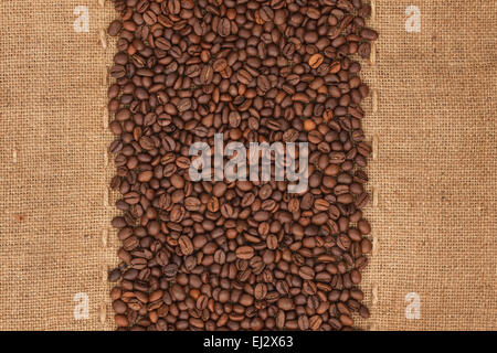 Coffee beans lying on sackcloth, with place for your text Stock Photo